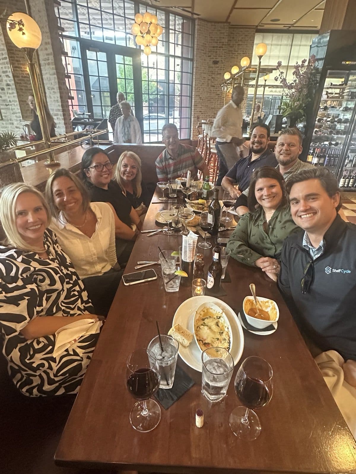 ShelfCycle and customer team members sharing a dinner table at a restaurant